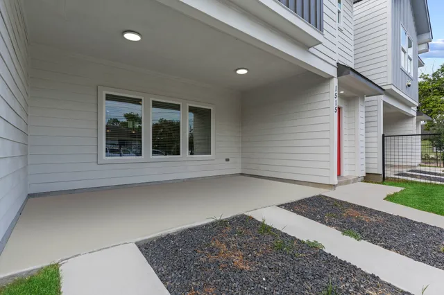 a view of a house with a backyard and a garage
