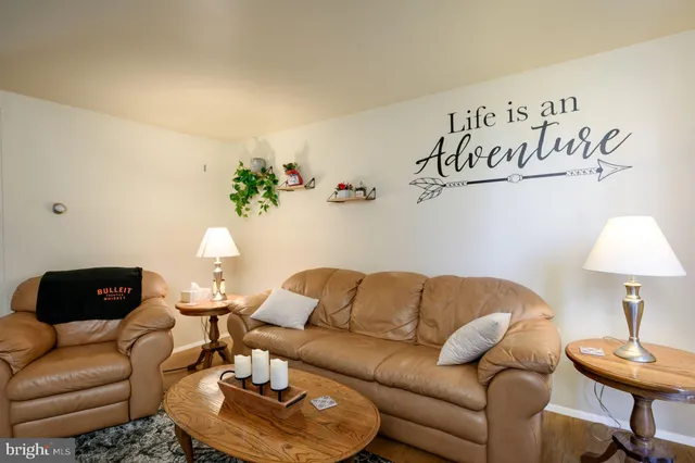 a living room with furniture and a lamp