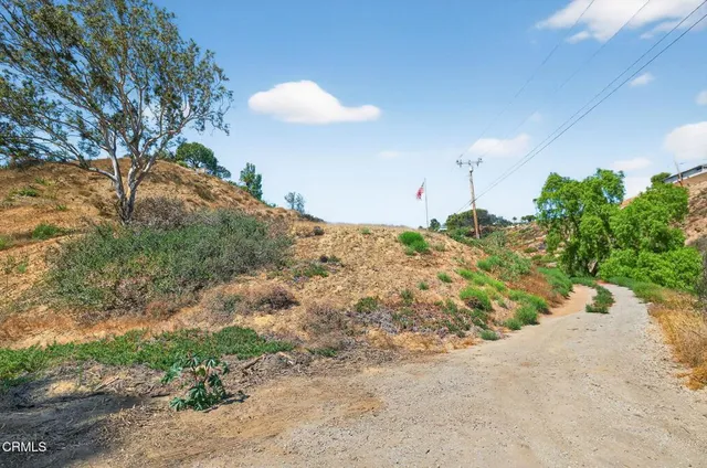 a view of a dry yard with a barn