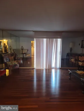 a view of a living room and a livingroom with furniture wooden floor windows and a fireplace