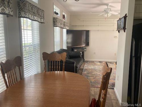 1661 Old Country Road, Unit 49 Riverhead, NY 11901 - Photo 6 of 11 a view of a dining room with furniture window and outside view
