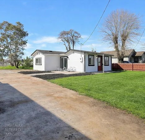 a big house with a big yard and large trees