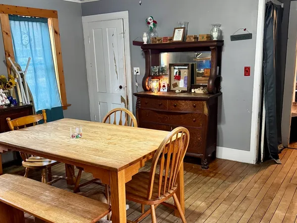 a dining room with furniture and wooden floor