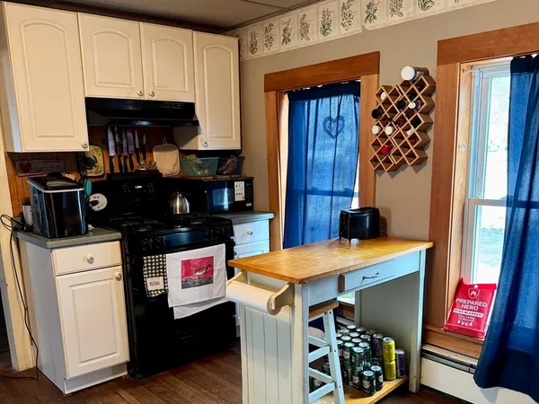 a kitchen with a refrigerator and a stove top oven