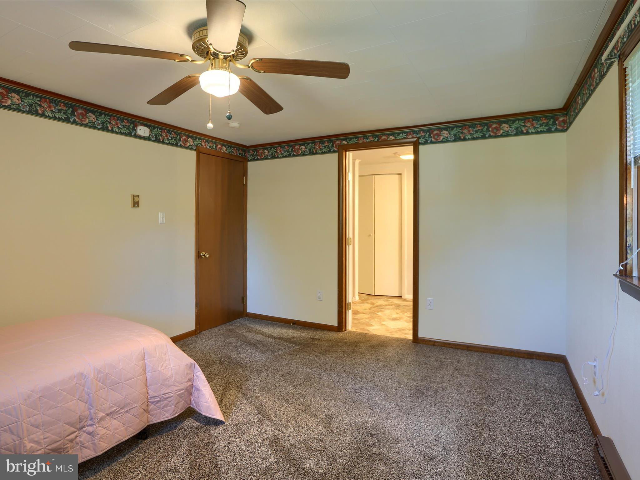 5333 Spruce Road Fayetteville, PA 17222 - Photo 19 of 40 a bedroom with a bed and a chandelier