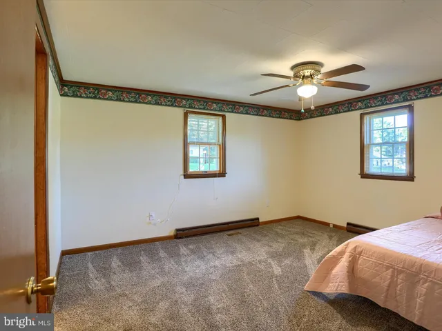 a bedroom with bed and a window