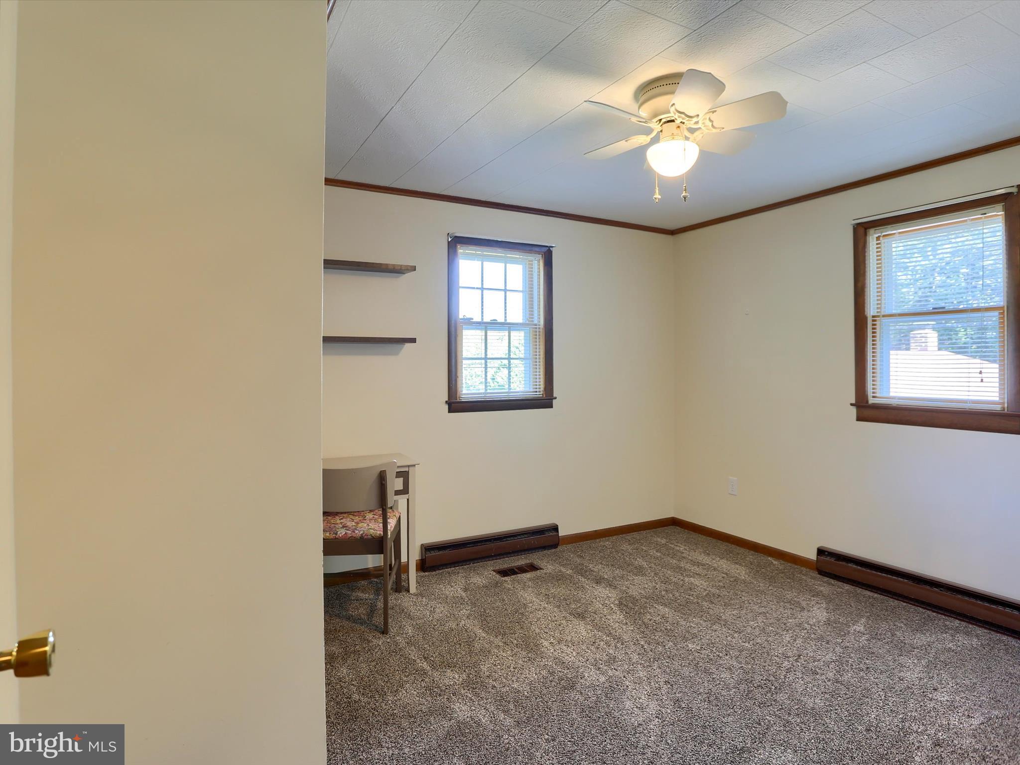 5333 Spruce Road Fayetteville, PA 17222 - Photo 26 of 40 an empty room with a chandelier fan and windows