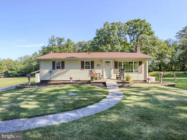 a view of a house with a yard patio and swimming pool