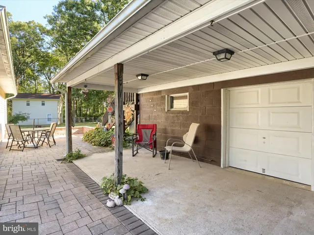 a view of a patio with table and chairs and potted plants