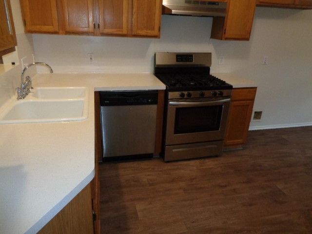 17823 Poppy Trails Lane Houston, TX 77084 - Photo 12 of 22 a kitchen with granite countertop a stove and a sink