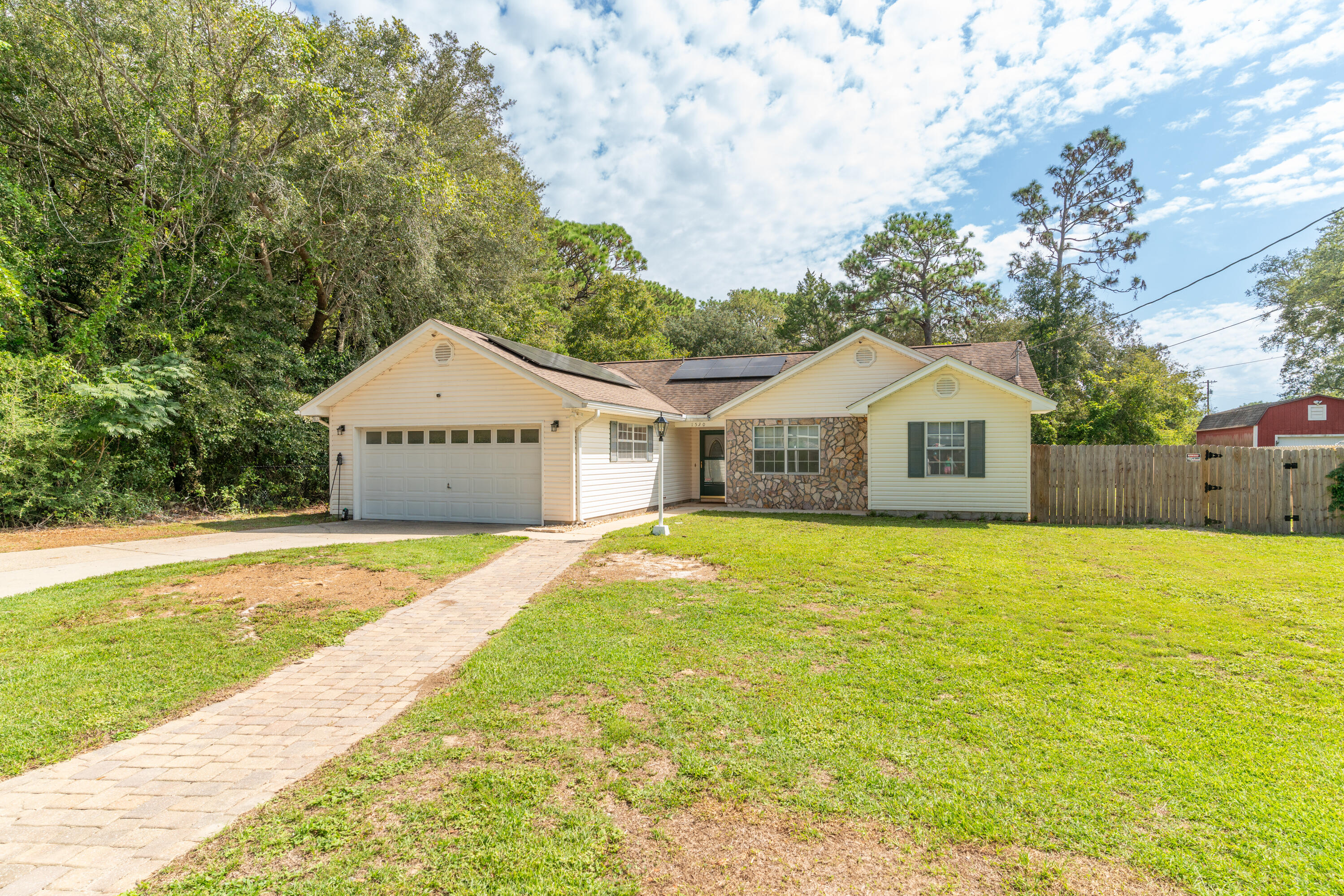 a front view of a house with yard and garage