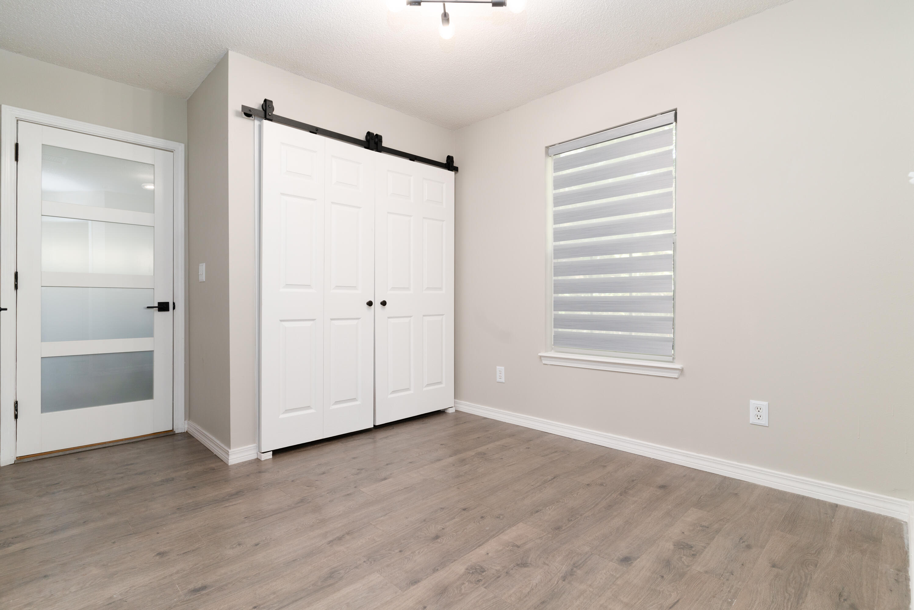 1530 Heritage Road Fort Walton Beach, FL 32547 - Photo 19 of 37 a view of an empty room with wooden floor and a window