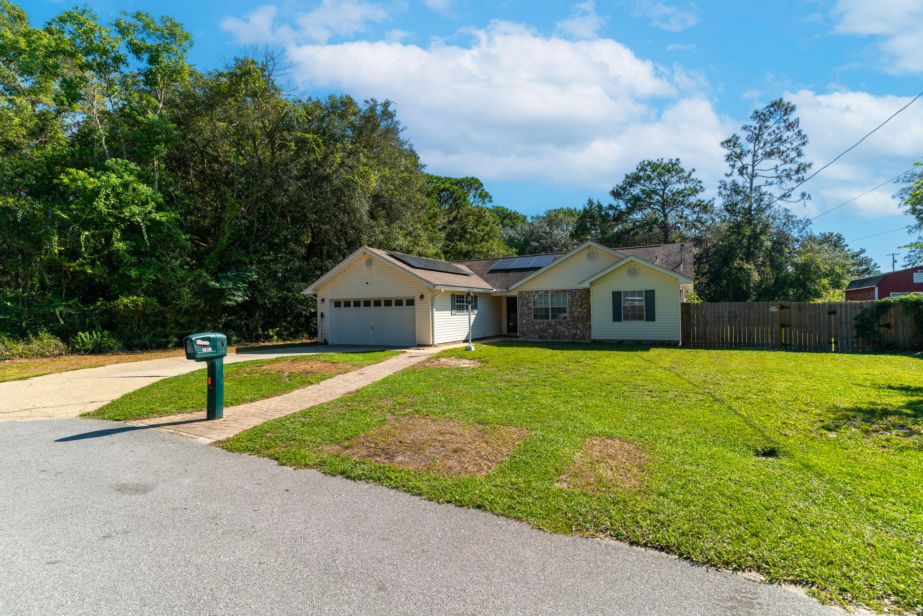 1530 Heritage Road Fort Walton Beach, FL 32547 - Photo 2 of 37 a front view of a house with garden