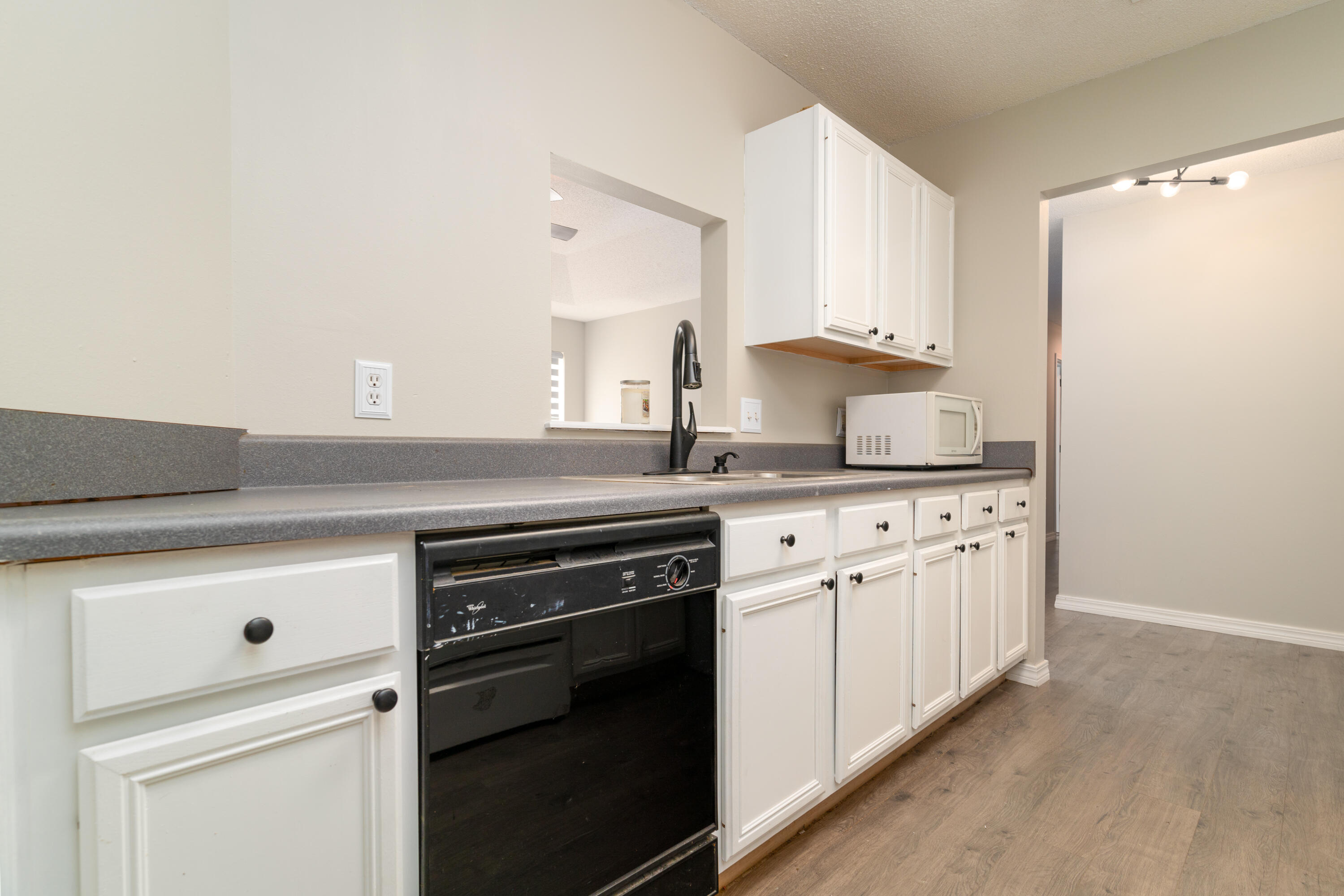 1530 Heritage Road Fort Walton Beach, FL 32547 - Photo 22 of 37 a kitchen with granite countertop white cabinets and white appliances
