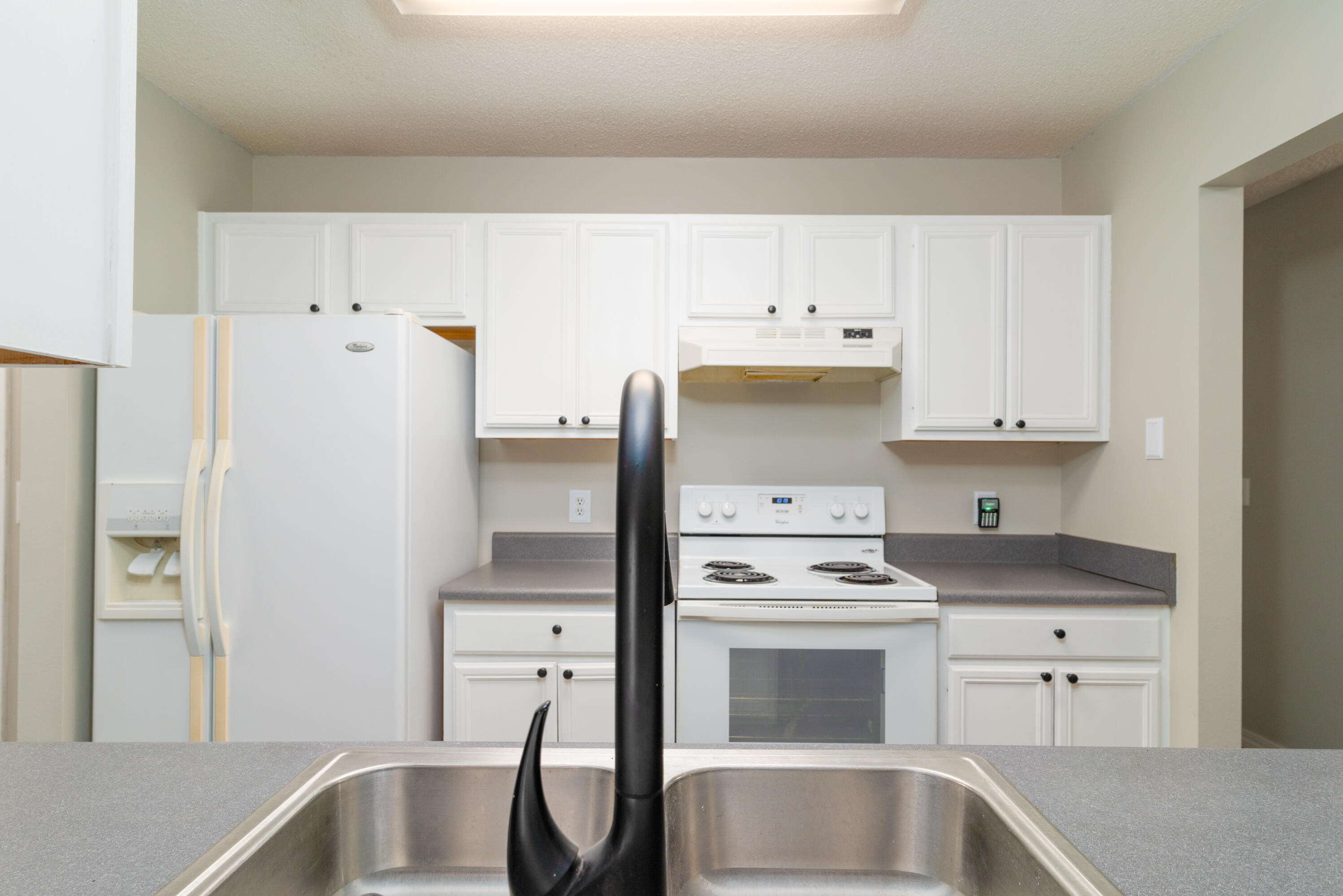 1530 Heritage Road Fort Walton Beach, FL 32547 - Photo 24 of 37 a kitchen with white cabinets and white appliances