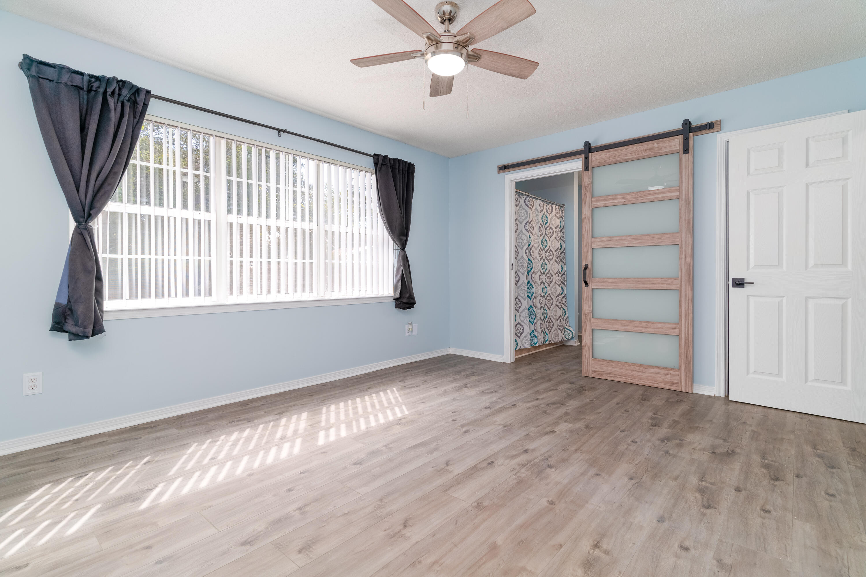 1530 Heritage Road Fort Walton Beach, FL 32547 - Photo 26 of 37 a view of an empty room with a window and wooden floor