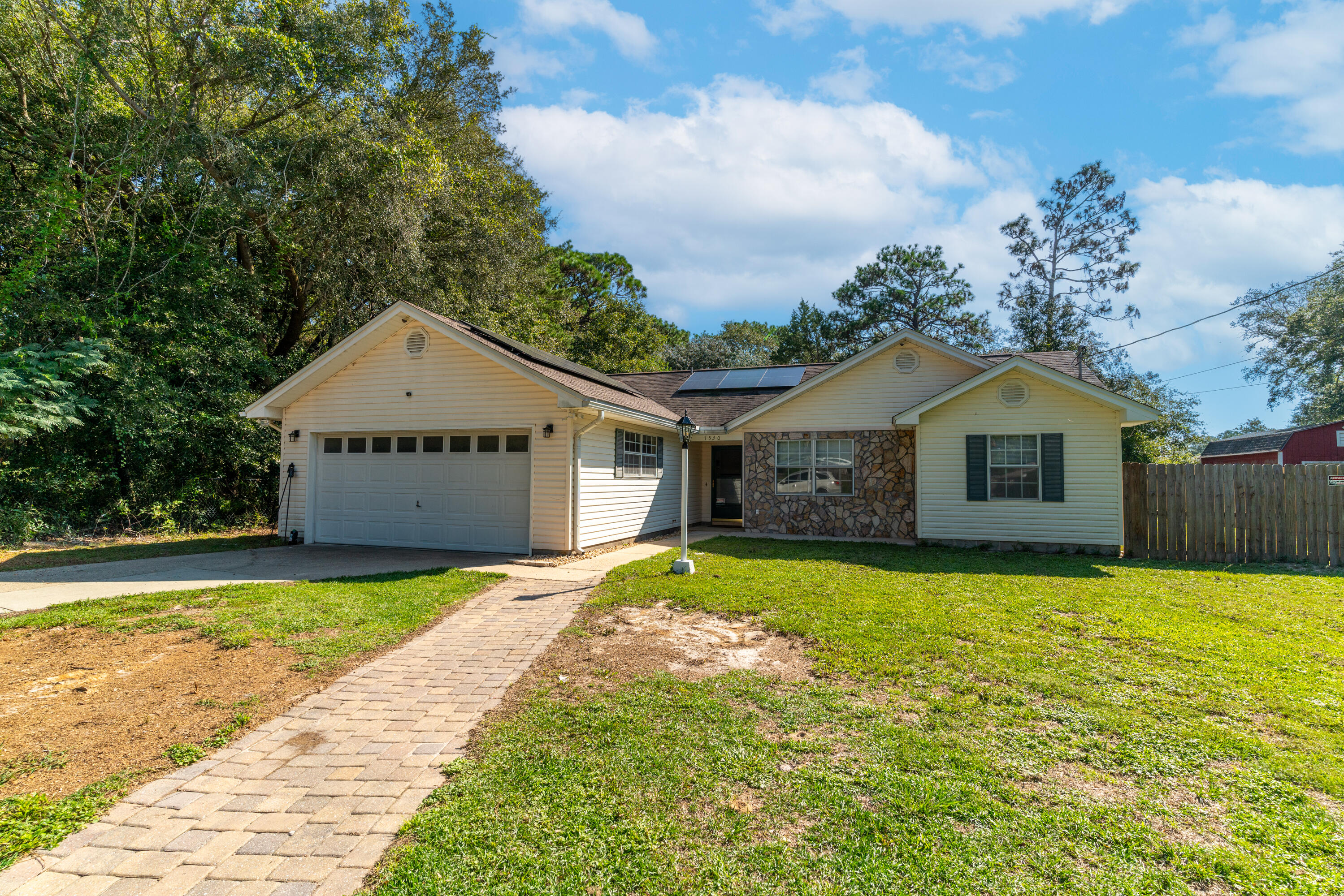 1530 Heritage Road Fort Walton Beach, FL 32547 - Photo 3 of 37 a front view of a house with a yard and garage