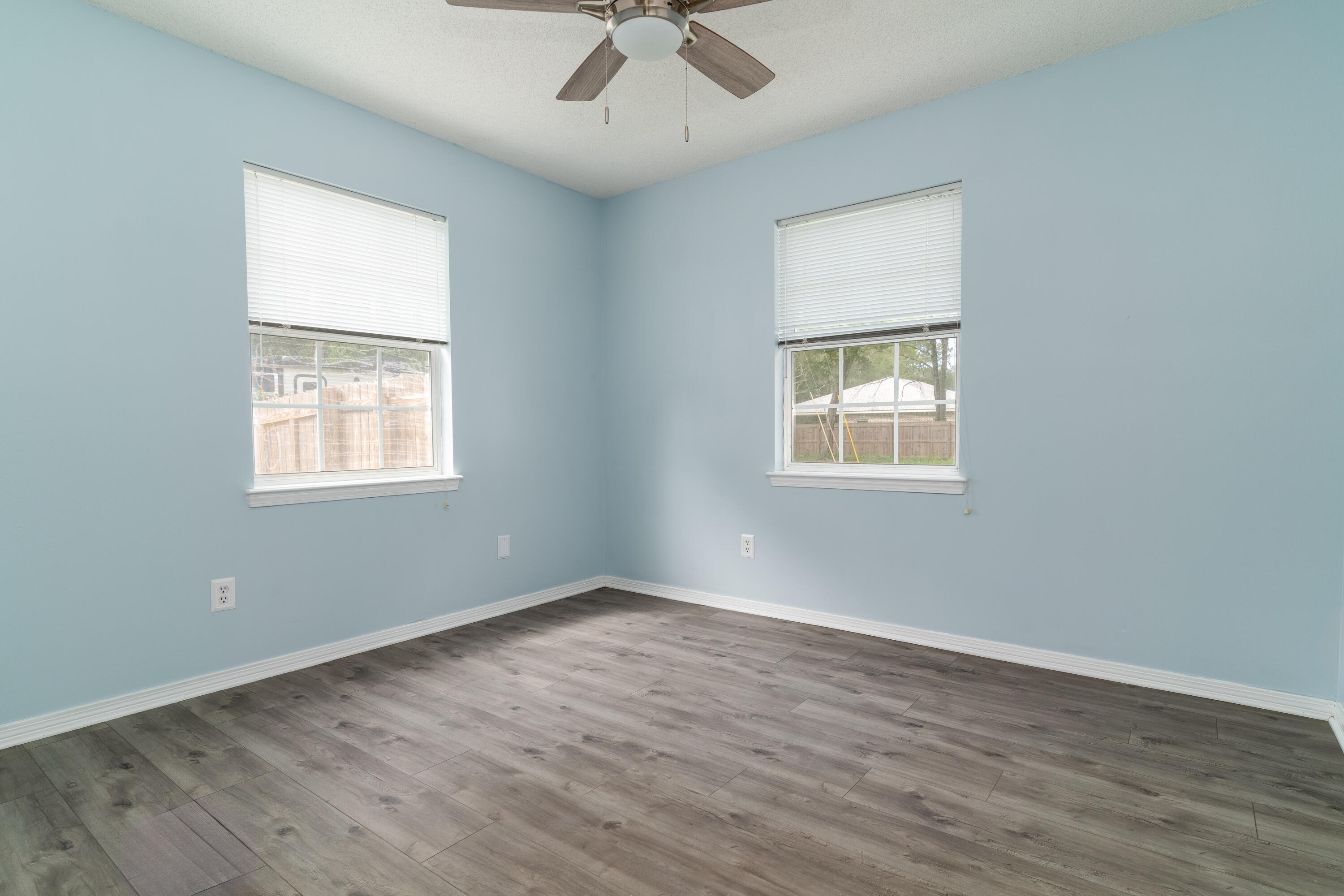 1530 Heritage Road Fort Walton Beach, FL 32547 - Photo 34 of 37 a view of an empty room with wooden floor and a window