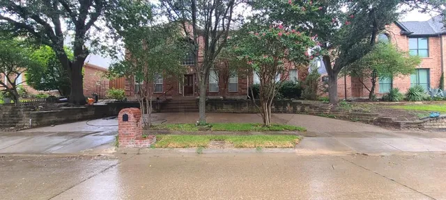 a backyard of a house with barbeque oven table and chairs