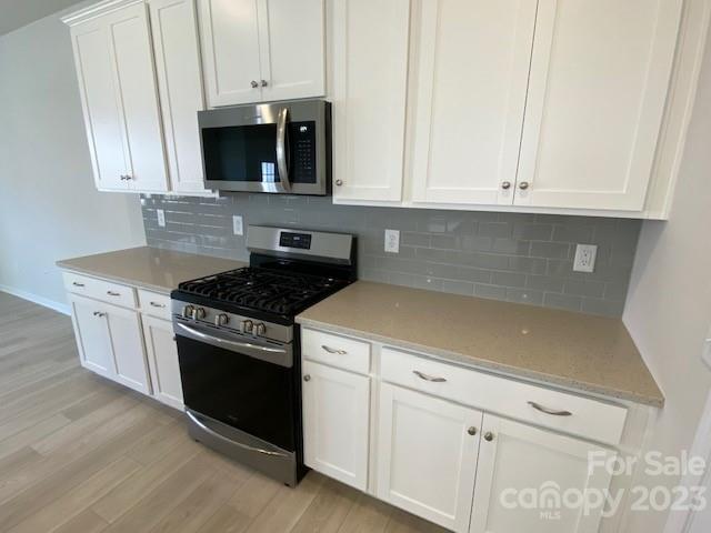 933 Cobbled Way, Unit 35 Fort Mill, SC 29715 - Photo 14 of 30 a kitchen with stainless steel appliances granite countertop white cabinets and stove