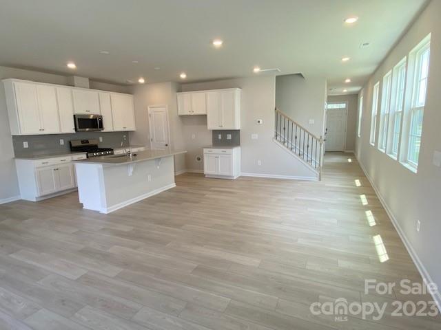 933 Cobbled Way, Unit 35 Fort Mill, SC 29715 - Photo 17 of 30 a view of kitchen with kitchen island granite countertop a stove top oven a sink a counter top space and cabinets