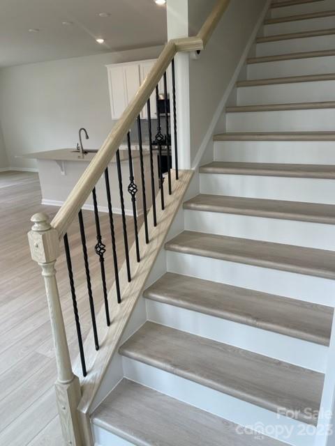 933 Cobbled Way, Unit 35 Fort Mill, SC 29715 - Photo 20 of 30 a view of staircase with wooden floor and white walls