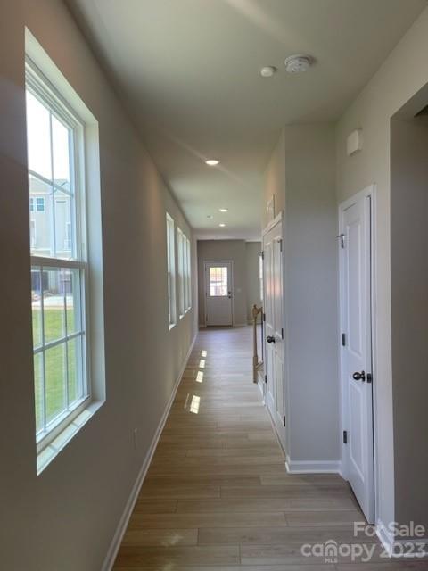 933 Cobbled Way, Unit 35 Fort Mill, SC 29715 - Photo 3 of 30 a view of hallway with stairs and wooden floor