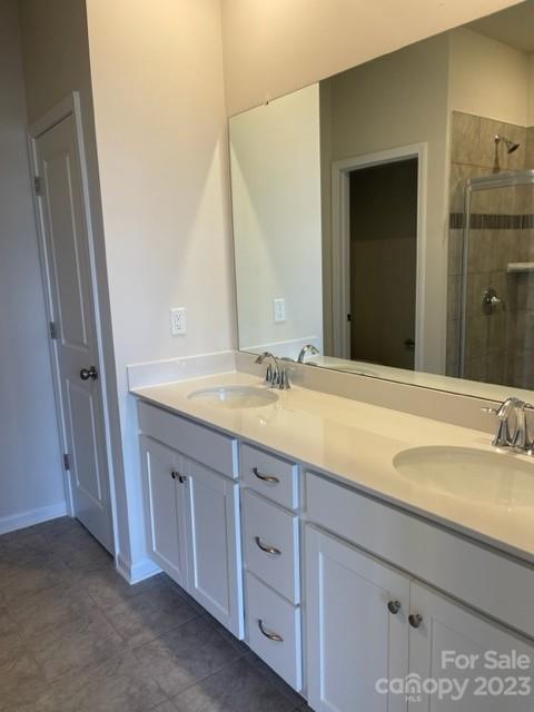 933 Cobbled Way, Unit 35 Fort Mill, SC 29715 - Photo 6 of 30 a bathroom with a granite countertop sink and a mirror