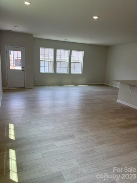 933 Cobbled Way, Unit 35 Fort Mill, SC 29715 - Photo 10 of 30 a view of an empty room with wooden floor and a window