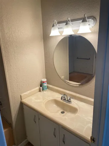 a bathroom with a sink and a mirror