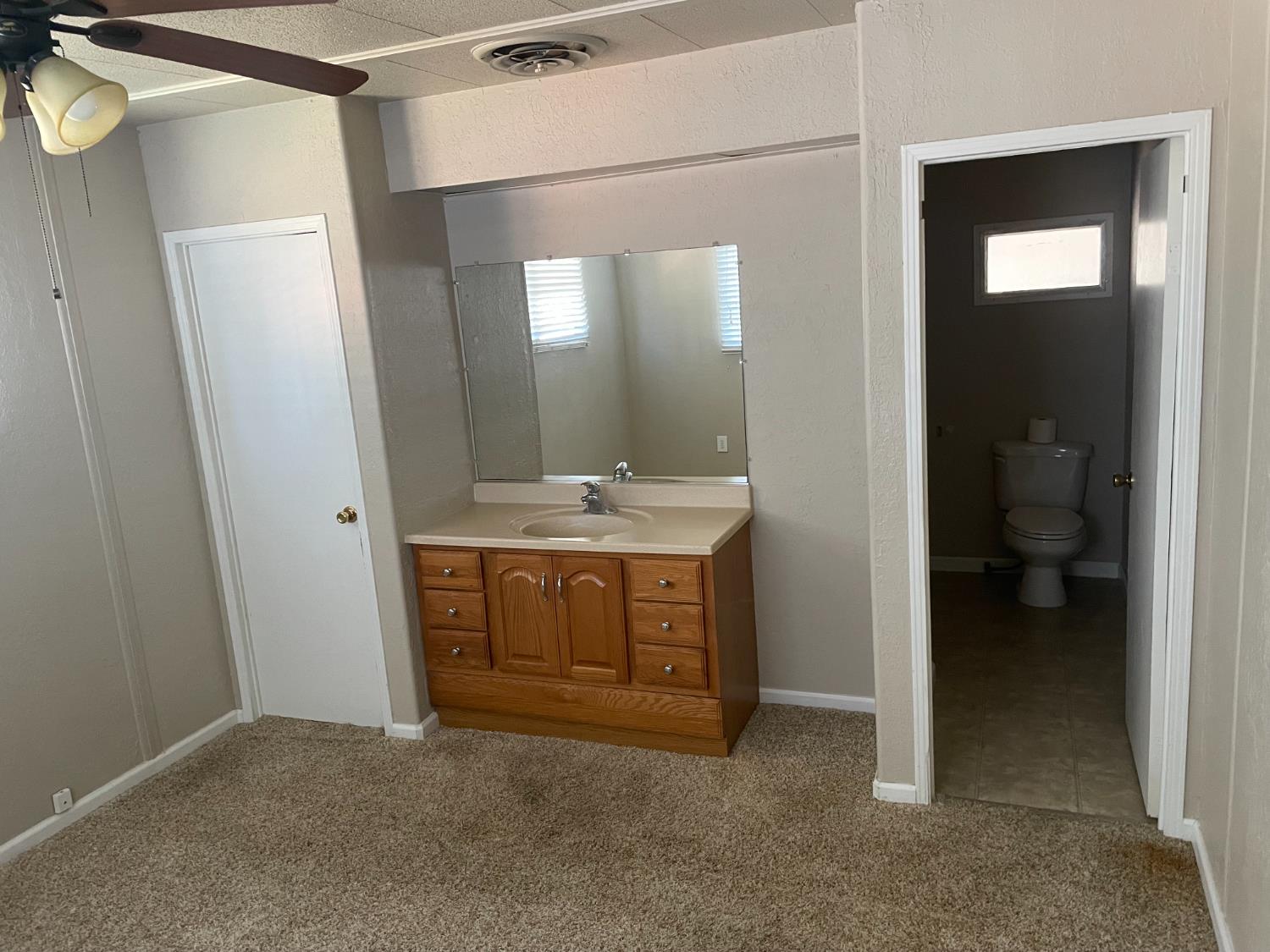 5835 Cherokee Road, Unit 61 Stockton, CA 95215 - Photo 8 of 10 a bathroom with a sink and a mirror