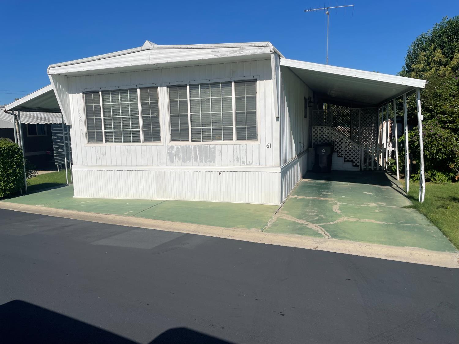 5835 Cherokee Road, Unit 61 Stockton, CA 95215 - Photo 10 of 10 a view of a house with a yard and garage