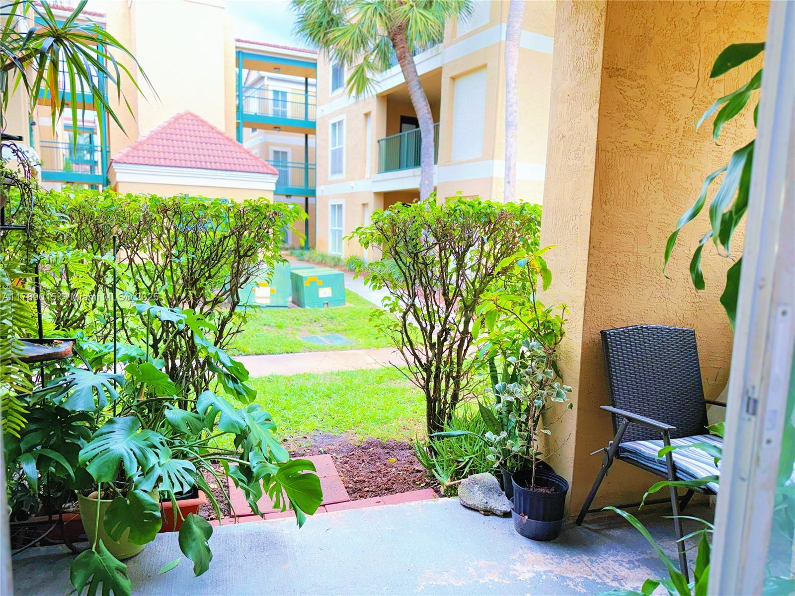 805 Riverside Drive, Unit 1111 Coral Springs, FL 33071 - Photo 14 of 16 a backyard of a house with a garden and outdoor seating