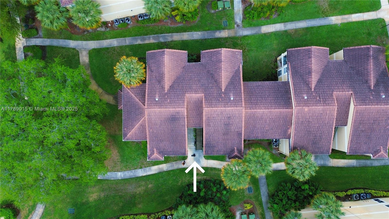 805 Riverside Drive, Unit 1111 Coral Springs, FL 33071 - Photo 15 of 16 an aerial view of a house with a yard and a garden