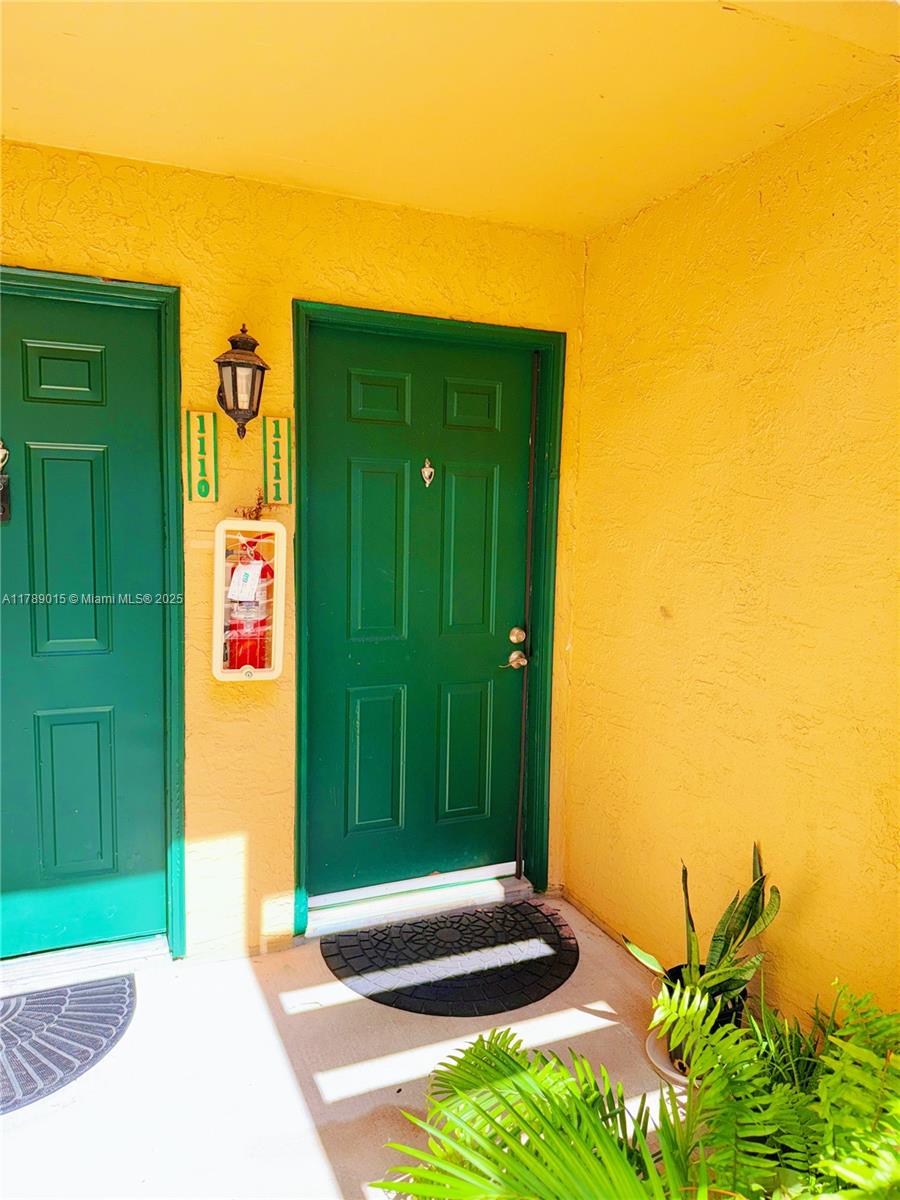 805 Riverside Drive, Unit 1111 Coral Springs, FL 33071 - Photo 3 of 16 a front view of a house with a yard