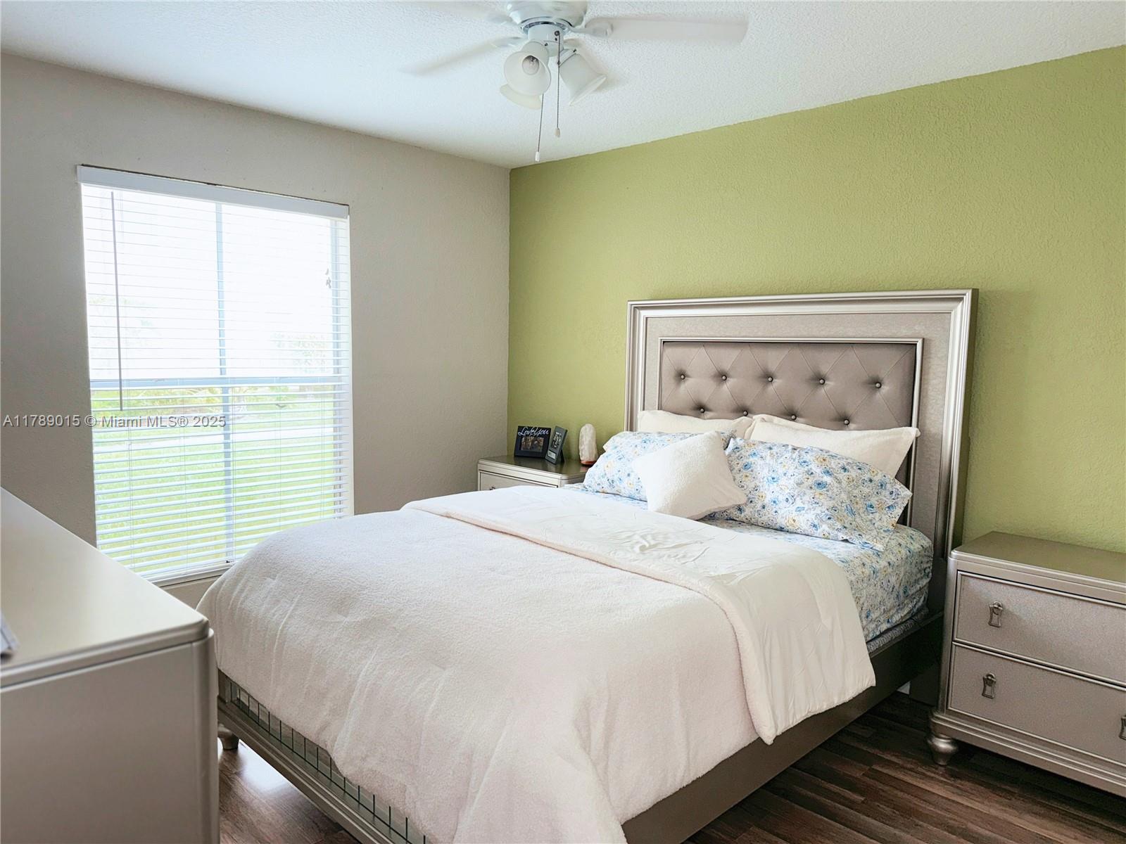 805 Riverside Drive, Unit 1111 Coral Springs, FL 33071 - Photo 9 of 16 a bedroom with a bed and a chandelier