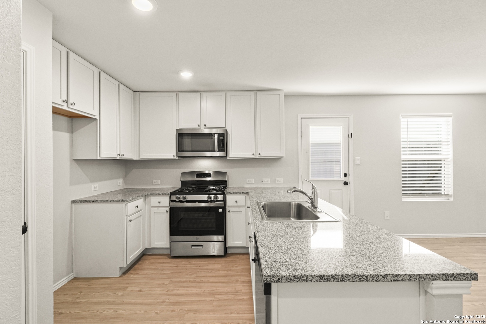 6430 Level Flight Converse, TX 78109 - Photo 6 of 19 a kitchen with stainless steel appliances granite countertop a sink stove and refrigerator