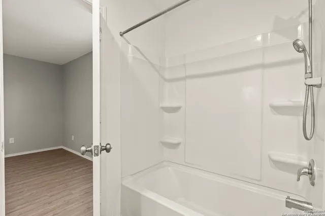 a bathroom with a bathtub and a shower