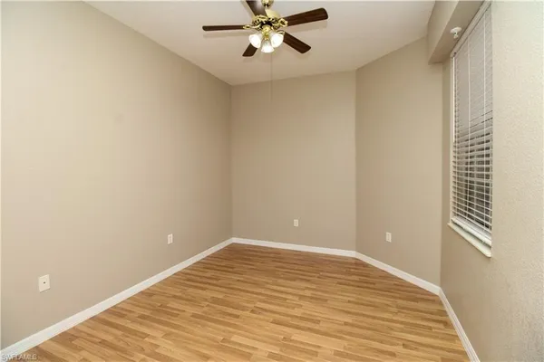 a view of room with window and ceiling fan