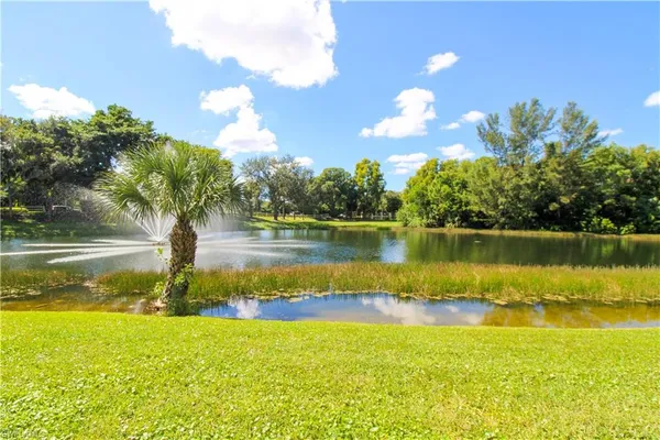 a view of a lake from a yard with swimming pool and outdoor space