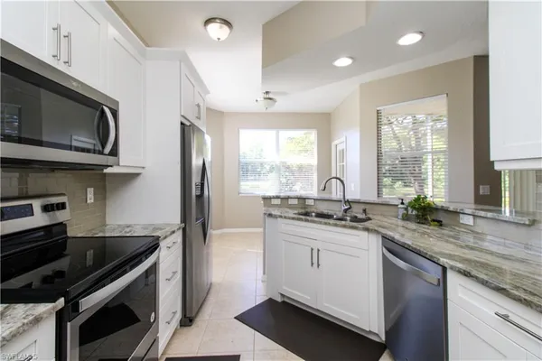 a kitchen with stainless steel appliances a sink stove and cabinets
