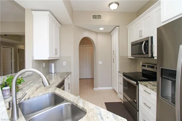 a kitchen with a sink cabinets and stainless steel appliances