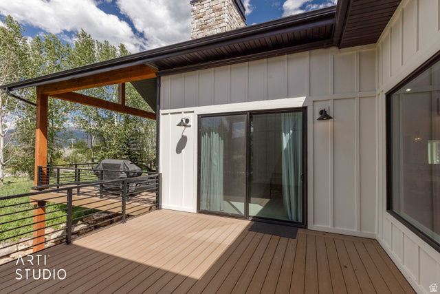 1188 South Old Trappers Loop Road Huntsville, UT 84317 - Photo 69 of 92 Expansive deck featuring composite wood-finish flooring, black metal railings, and a covered section with wood beams