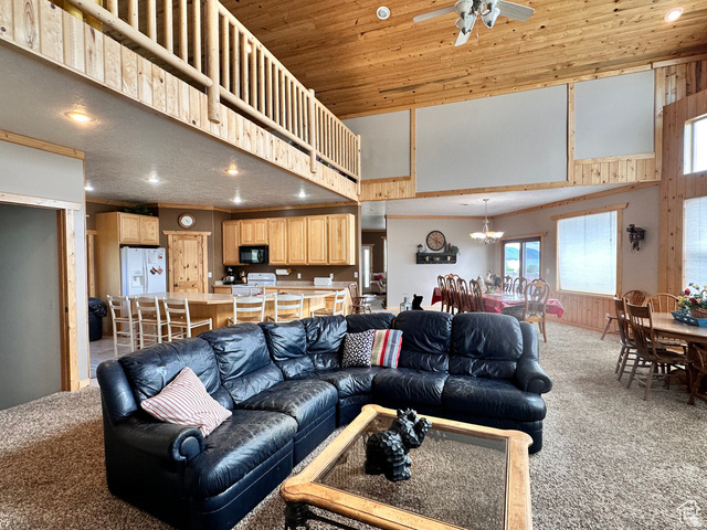 1940 East Shore Road St. Charles, ID 83272 - Photo 19 of 64 Living area featuring light carpet, recessed lighting, a high wooden ceiling, and ceiling fan