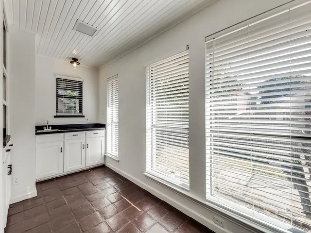 a room with a window and a kitchen