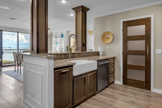 a kitchen with stainless steel appliances granite countertop a stove and a sink