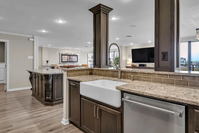 a kitchen with stainless steel appliances granite countertop a sink counter space and cabinets