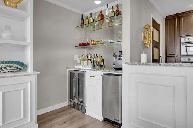 a room with a wooden floor and cabinets