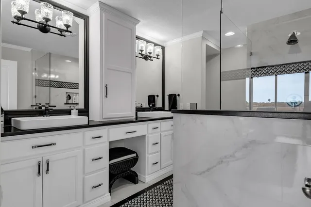 a bathroom with a double vanity sink a mirror and shower