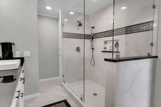 a bathroom with a shower and a glass door